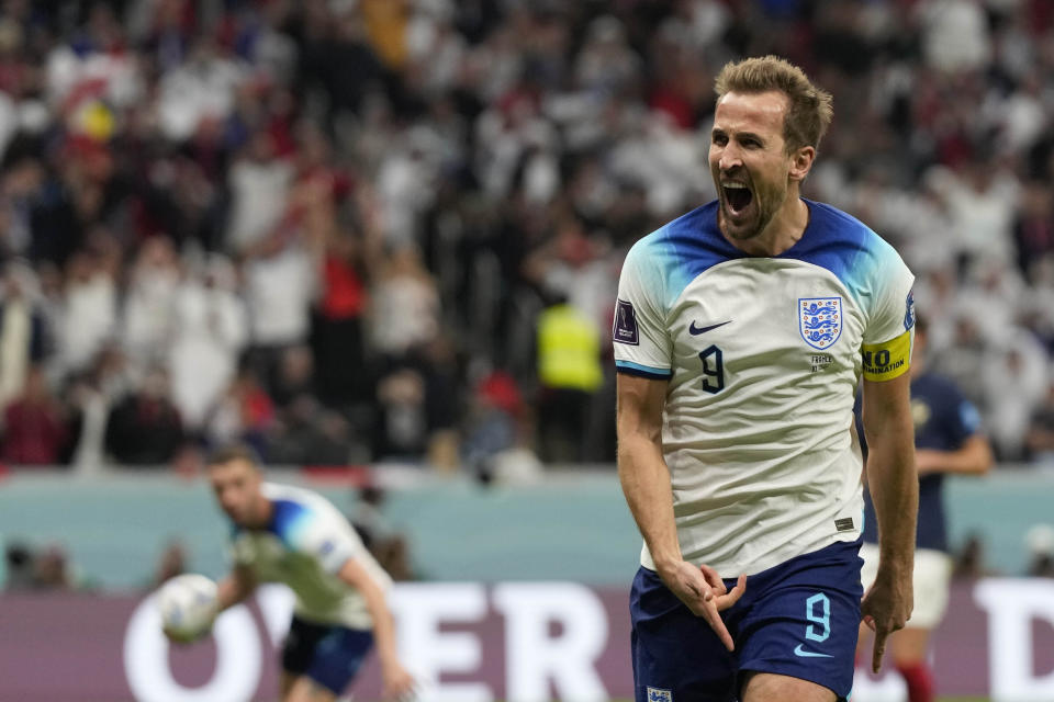 England's Harry Kane celebrates after scoring his side's opening goal during the World Cup quarterfinal soccer match between England and France, at the Al Bayt Stadium in Al Khor, Qatar, Saturday, Dec. 10, 2022. (AP Photo/Frank Augstein)