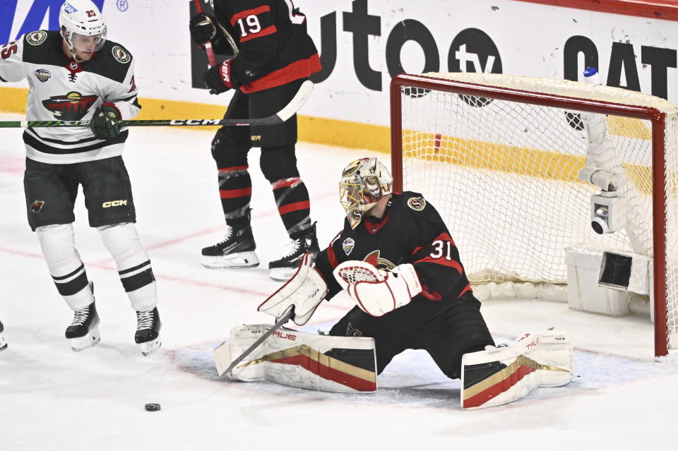 Minnesotas Jonas Brodin, left, and Ottawas goalkeeper Anton Forsbergi, right, in action during the NHL Global Series Sweden ice hockey match between Minnesota Wild and Ottawa Senators at Avicii Arena in Stockholm, Sweden, Saturday, Nov. 18, 2023. (Claudio Bresciani/TT News Agency via AP)