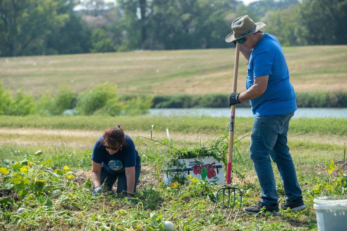 Mike and Jamie Duran volunteer at Opal’s Farm on Saturday, Oct. 8, 2022, in Fort Worth, Texas.