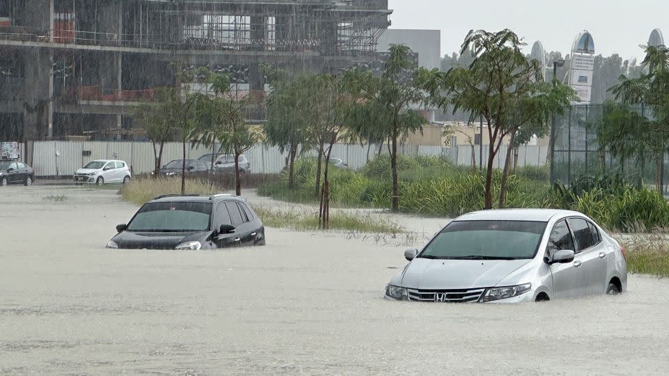 Cars drive through a flooded street during a rainstorm in Dubai. - Abdel Hadi Ramahi/Reuters