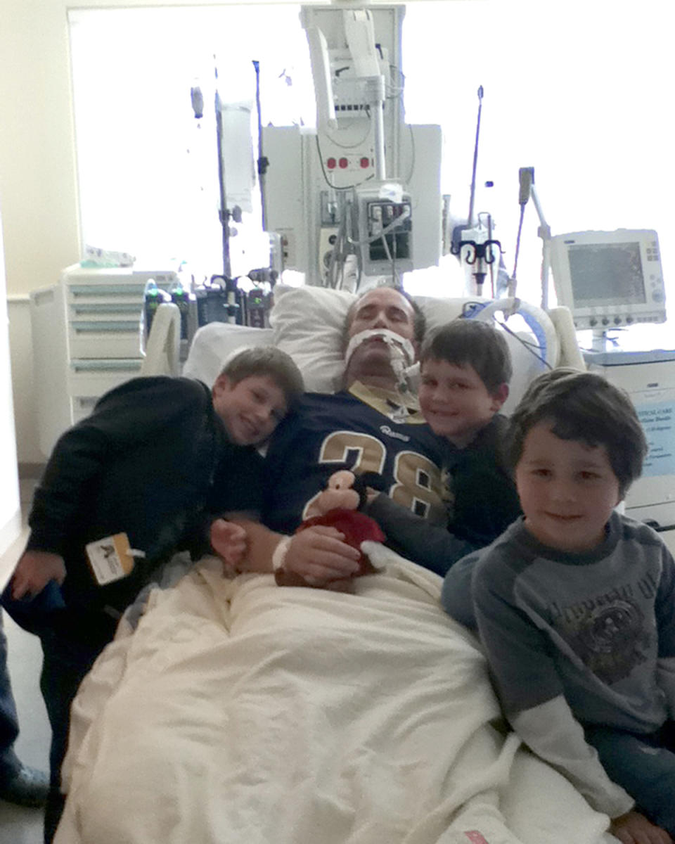 John Reynolds with his children in hospital shortly before his life support was turned off.