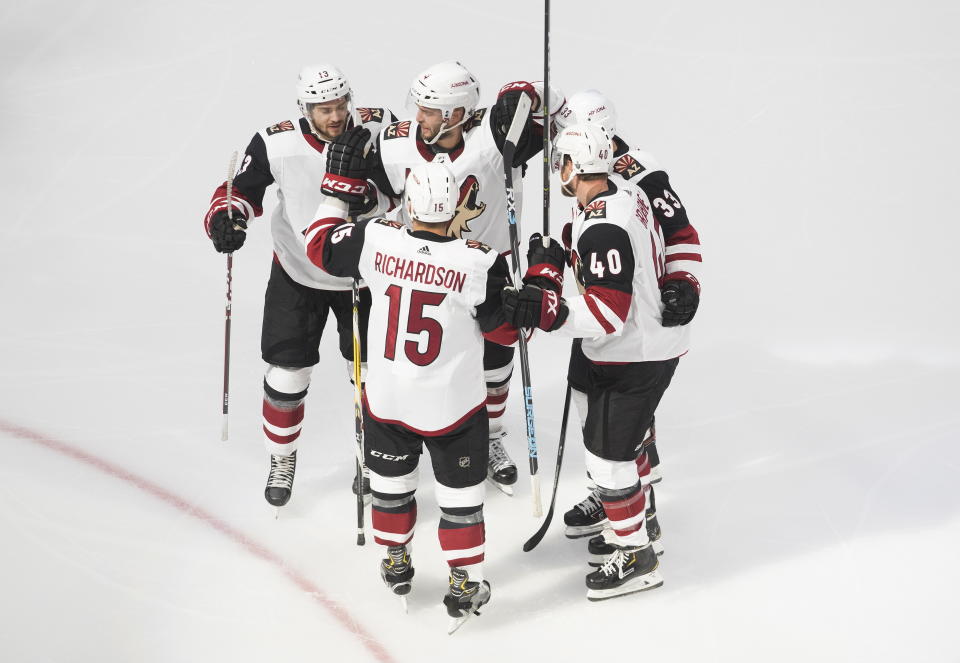 Arizona Coyotes celebrate a goal against the Colorado Avalanche during the second period of a first round NHL Stanley Cup playoff hockey series in Edmonton, Alberta, Friday, Aug. 14, 2020. (Jason Franson/The Canadian Press via AP)