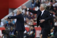 Mallorca's head coach Javier Aguirre, left and Real Madrid's head coach Carlo Ancelotti gesture during a Spanish La Liga soccer match between Mallorca and Real Madrid at the Son Moix stadium in Palma de Mallorca, Spain, Saturday, April 13, 2024. (AP Photo/Francisco Ubilla)