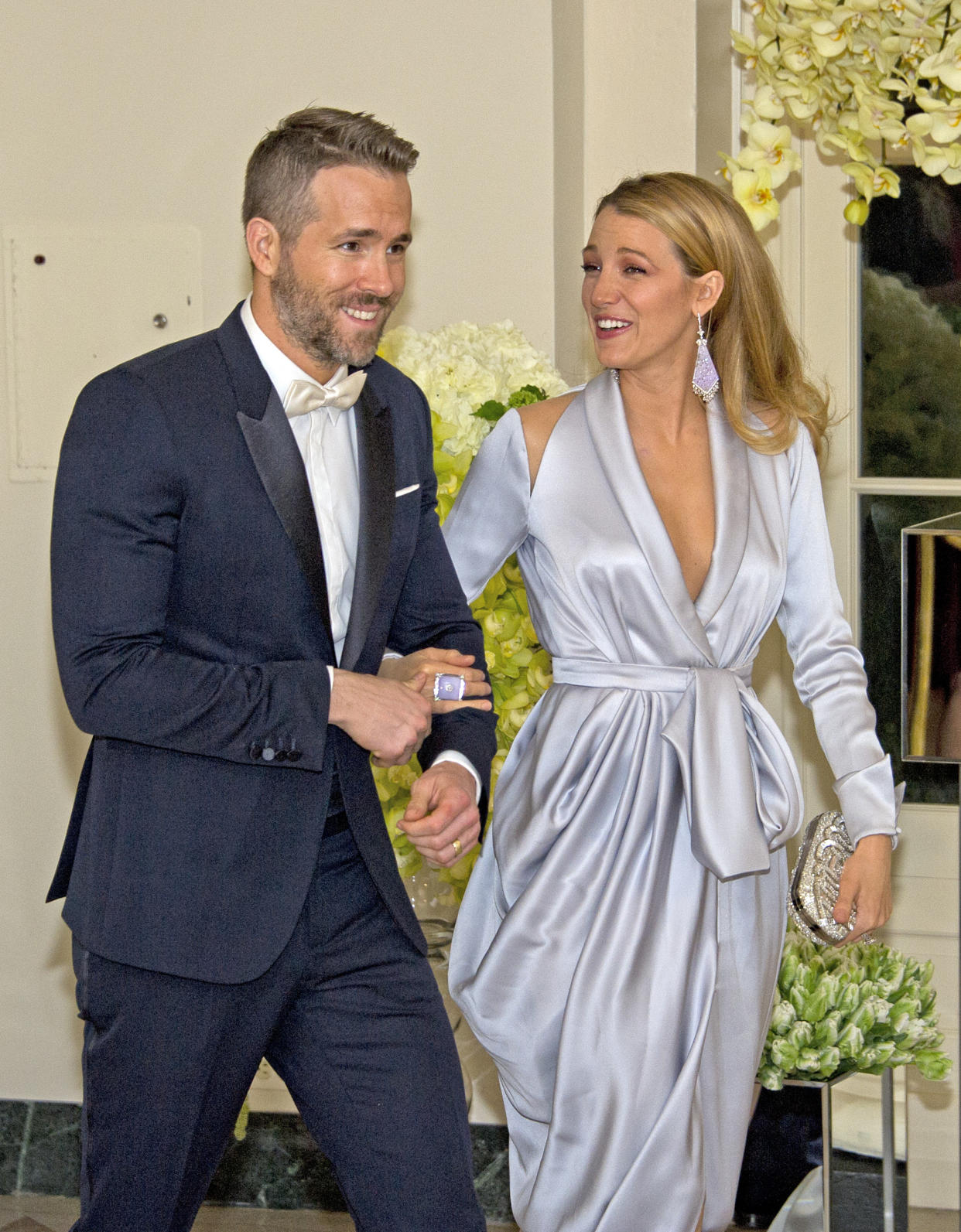 Ryan Reynolds arm-in-arm with Blake Lively at an event