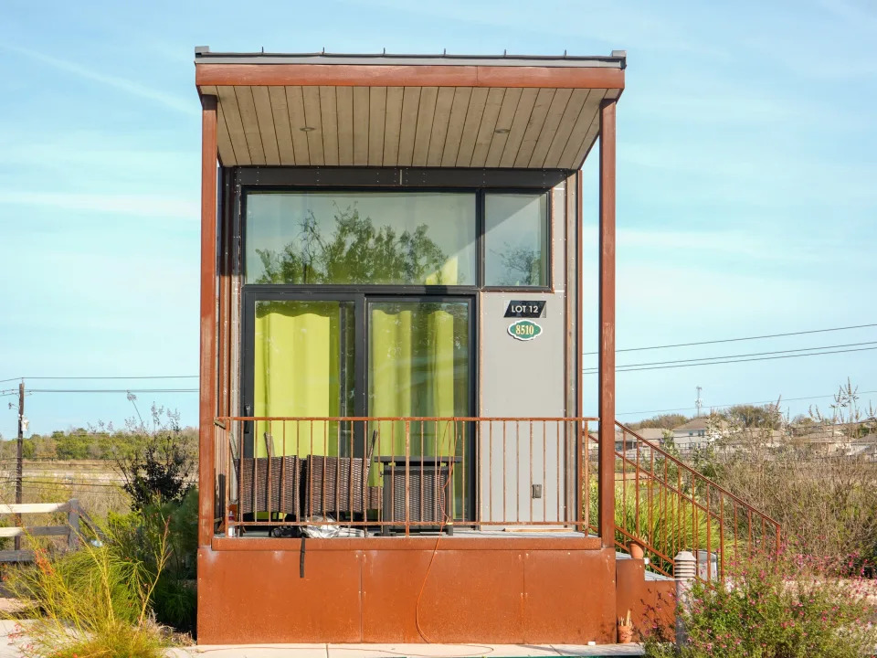 A tiny home with blue skies behind it