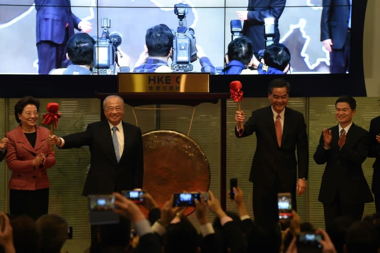 HKEX Chairman CK Chow (2nd L) and Hong Kong's Chief Executive Leung Chun-ying (2nd R) prepare to strike a gong to mark the start of the Shenzhen-Hong Kong Stock Connect, on December 5, 2016