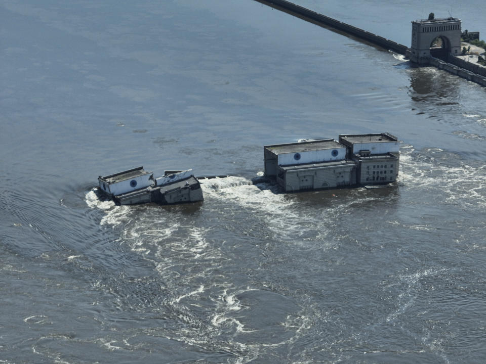 CAPTION CORRECTS LOCATION - Water flows over the collapsed Kakhovka dam in Nova Kakhovka, in Russian-occupied Ukraine, Wednesday, June 7, 2023. (AP Photo)