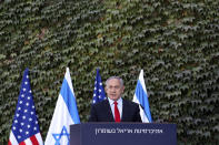 Israeli Prime Minister Benjamin Netanyahu speaks during a ceremony to sign amendments to a series of scientific cooperation agreements with U.S. Ambassador to Israel David Friedman, at Ariel University, in the West Bank settlement of Ariel, Wednesday, Oct. 28, 2020. The United States and Israel amended the agreements on Wednesday to include Israeli institutions in the West Bank, a step that further blurs the status of settlements widely considered illegal under international law. (Emil Salman/Pool via AP)