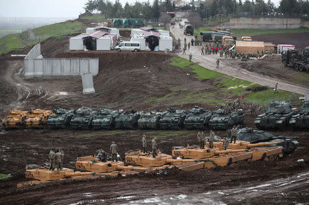 Turkish army tanks and armoured personnel carriers (APC) are seen near the Turkish-Syrian border in Hatay province, Turkey January 23, 2018. REUTERS/Umit Bektas