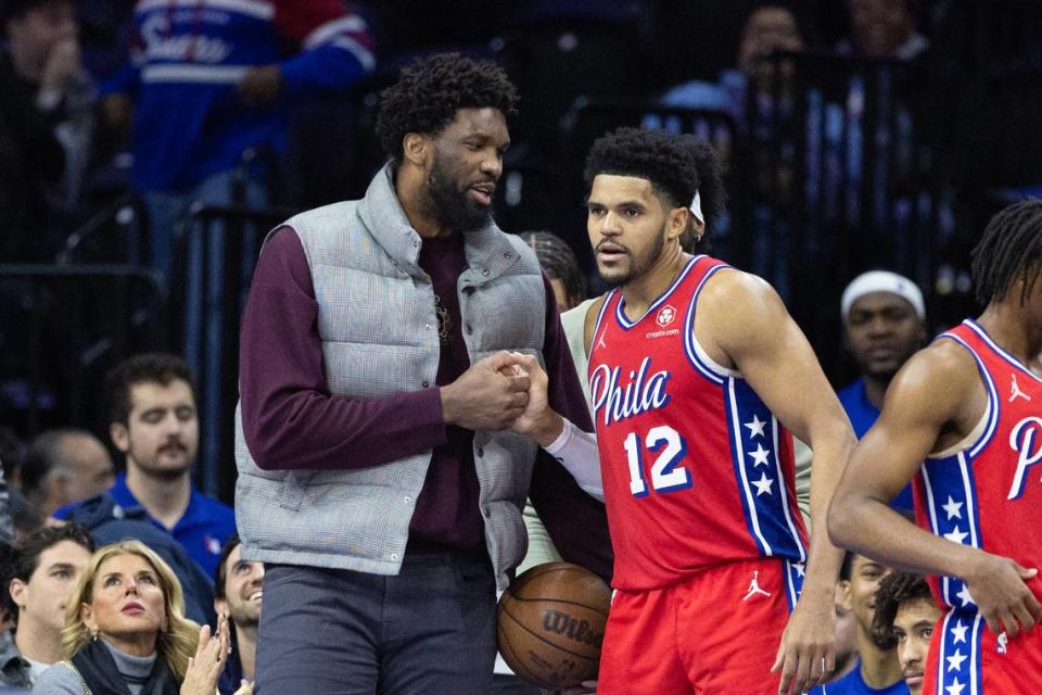 Philadelphia 76ers forward Tobias Harris (12) shakes hands with Philadelphia 76ers center Joel Embiid, left, after exiting the game with 37 points Friday at Wells Fargo Center in Philadelphia.