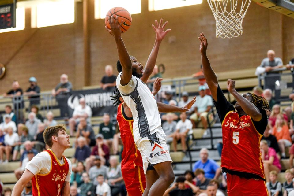 Team Snip Back and Michigan State's Tre Holloman scores against Team 5 Star during the Moneyball Pro-Am on Tuesday, July 18, 2023, at Holt High School.