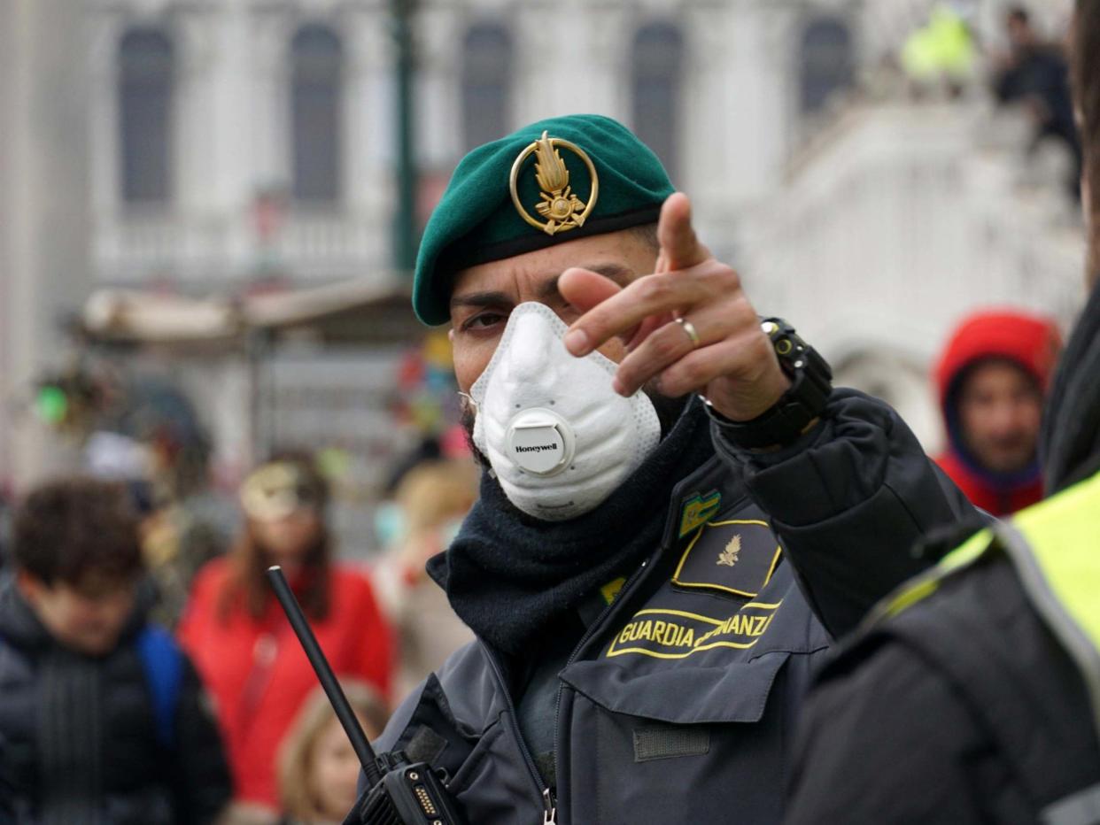 A police officer wears a face mask during the Venice Carnival in Italy: EPA