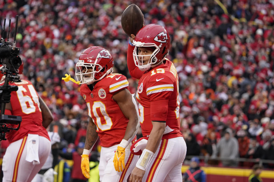 Kansas City Chiefs quarterback Patrick Mahomes (15) celebrates after throwing an 8-yard touchdown pass to running back Isiah Pacheco (10) during the first half of an NFL football game Sunday, Dec. 31, 2023, in Kansas City, Mo. (AP Photo/Ed Zurga)