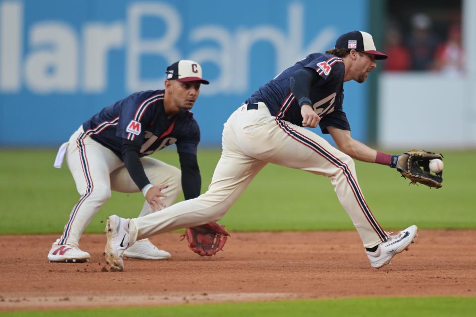 Jul 19, 2024; Cleveland, Ohio, USA; Cleveland Guardians shortstop Daniel Schneemann (10) fields a ball hit by San Diego Padres left fielder Jurickson Profar (not pictured) in front of second baseman Andres Gimenez (0) during the third inning at Progressive Field. Mandatory Credit: Ken Blaze-USA TODAY Sports