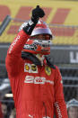 Ferrari driver Charles Leclerc of Monaco celebrates after setting the pole position at the end of the qualifying session practice at the 'Sochi Autodrom' Formula One circuit, in Sochi, Russia, Saturday, Sept.28, 2019. The Formula one race will be held on Sunday. (AP Photo/Luca Bruno)