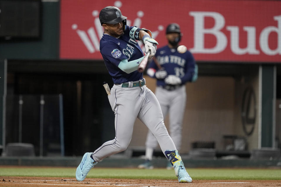 Seattle Mariners' Julio Rodriguez connects for a double in the first inning of a baseball game against the Texas Rangers, Saturday, Sept. 23, 2023, in Arlington, Texas. (AP Photo/Tony Gutierrez)