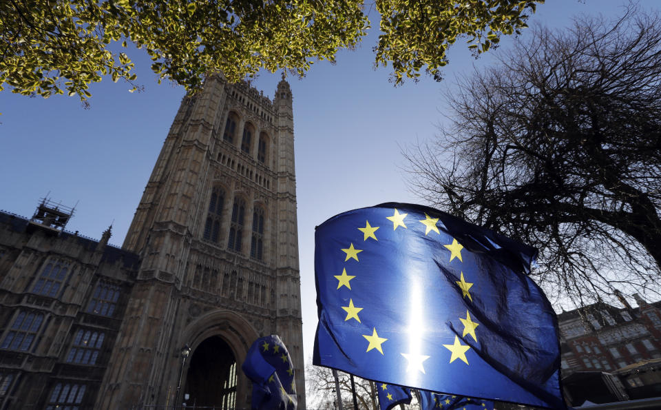 The sun shines through European Union flags tied to railings outside parliament in London, Tuesday, Jan. 22, 2019. British Prime Minister Theresa May unveiled her Brexit Plan B on Monday — and it looks a lot like Plan A. May launched a mission to resuscitate her rejected European Union divorce deal, setting out plans to get it approved by Parliament after securing changes from the EU to a contentious Irish border measure. (AP Photo/Kirsty Wigglesworth)