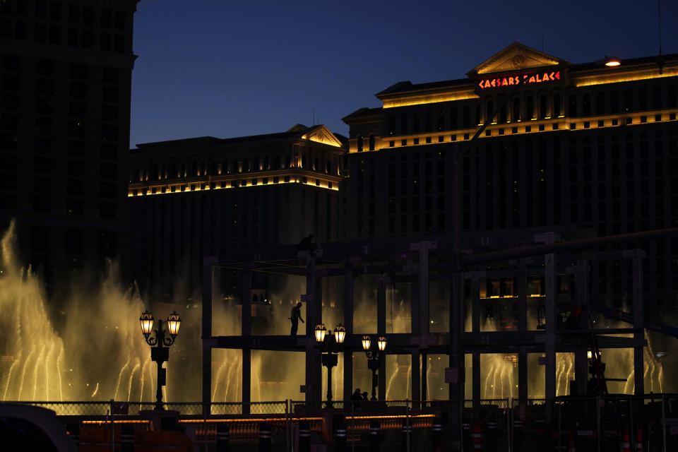 Construction workers build a grandstand in front of the fountains at Bellagio hotel-casino along the Las Vegas Strip ahead of the Las Vegas Formula One Grand Prix auto race Tuesday, Sept. 19, 2023, in Las Vegas. (AP Photo/John Locher)