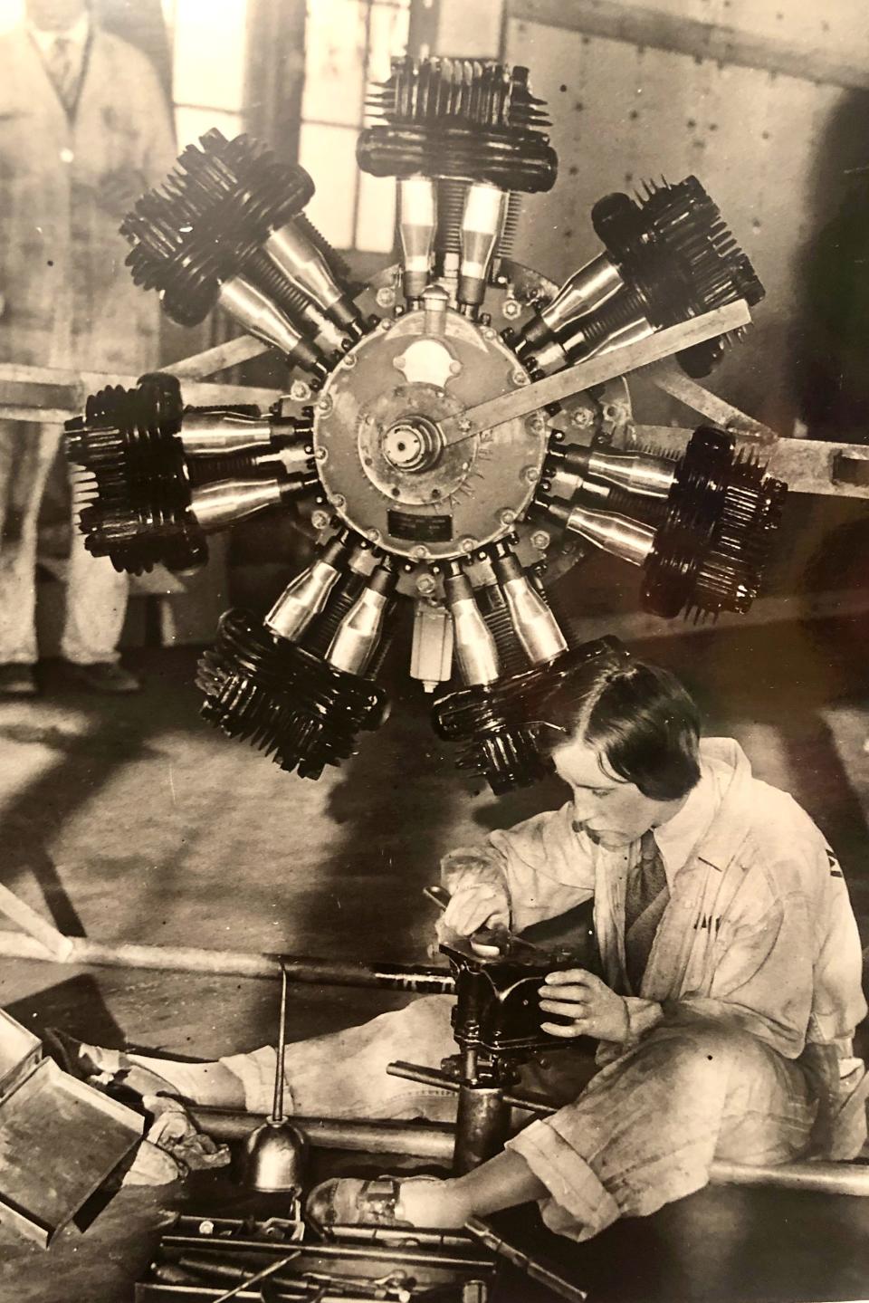 Vera Dawn Walker works on the engine of an airplane in this undated photo.