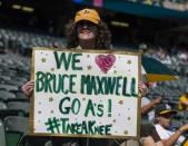 Sep 24, 2017; Oakland, CA, USA; Nancy Levine from Marin County holds up a sign in support of Oakland Athletics catcher Bruce Maxwell (not shown) before a game against the Texas Rangers at Oakland Coliseum. Mandatory Credit: John Hefti-USA TODAY Sports