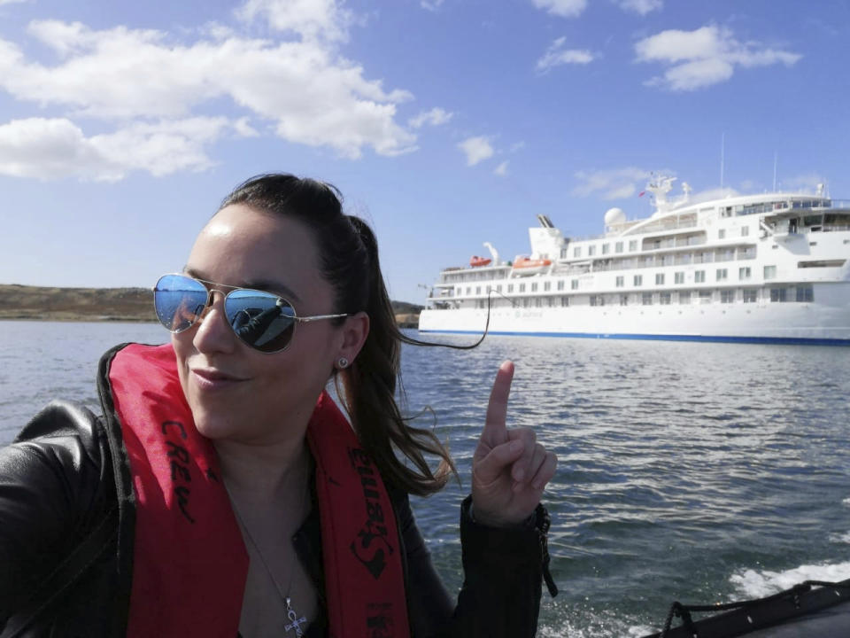 In this undated photo provided by Carolina Vasquez, she rides a tender in the Falkland Islands, as a crew member on board the Greg Mortimer, a ship operated by the Australian firm Aurora Expeditions and owned by a Miami company. Vasquez has been stuck in a cruise cabin with no windows and COVID-19. The ship is floating off the coast of Uruguay. Vasquez, 36, and tens of thousands of other crew members worldwide, including U.S. citizens, have been confined to cabins aboard ships, weeks after governments and cruise lines negotiated disembarkation for passengers arriving in vessels with infections. (Carolina Vasquez via AP)