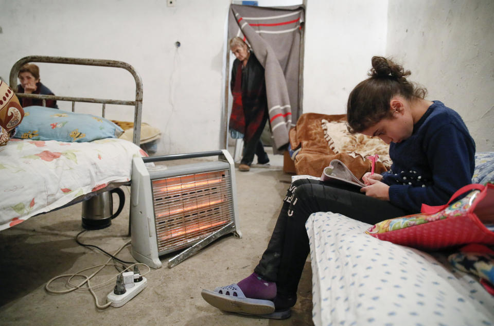 People take refuge in a bomb shelter in Stepanakert, the separatist region of Nagorno-Karabakh, Thursday, Oct. 22, 2020. Heavy fighting over Nagorno-Karabakh continued Thursday with Armenia and Azerbaijan trading blame for new attacks, hostilities that raised the threat of Turkey and Russia being drawn into the conflict. (AP Photo)