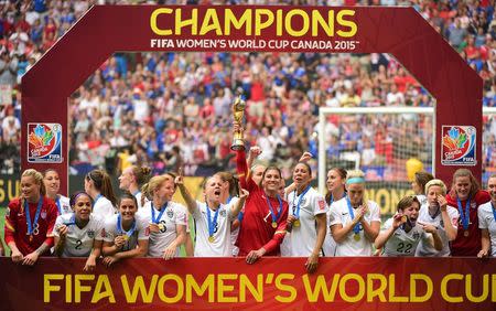 United States goalkeeper Hope Solo (1) hoists the FIFA Women's World Cup trophy as she and her teammates pose with their medals after defeating Japan in the final of the FIFA 2015 Women's World Cup in Vancouver July 5, 2015. Mandatory Credit: Anne-Marie Sorvin-USA TODAY Sports