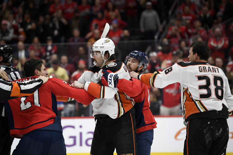 Washington Capitals right wing Garnet Hathaway (21) scuffles with Anaheim Ducks defenseman Erik Gudbranson, second from left, during the second period of an NHL hockey game, Monday, Nov. 18, 2019, in Washington. Also seen is Capitals center Chandler Stephenson, second from right, and Ducks center Derek Grant (38). (AP Photo/Nick Wass)