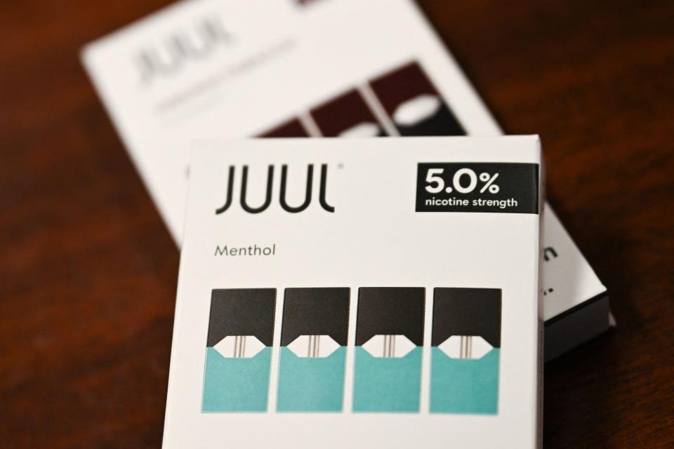 JUUL tobacco and menthol flavored vaping e-cigarette products are displayed in a convenience store.