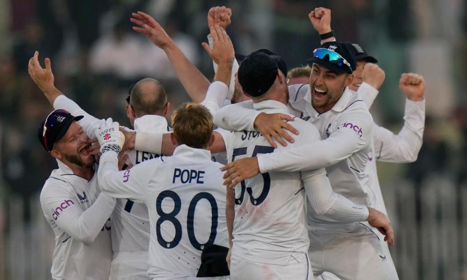 England celebrate their win over Pakistan in fading light at Rawalpindi.