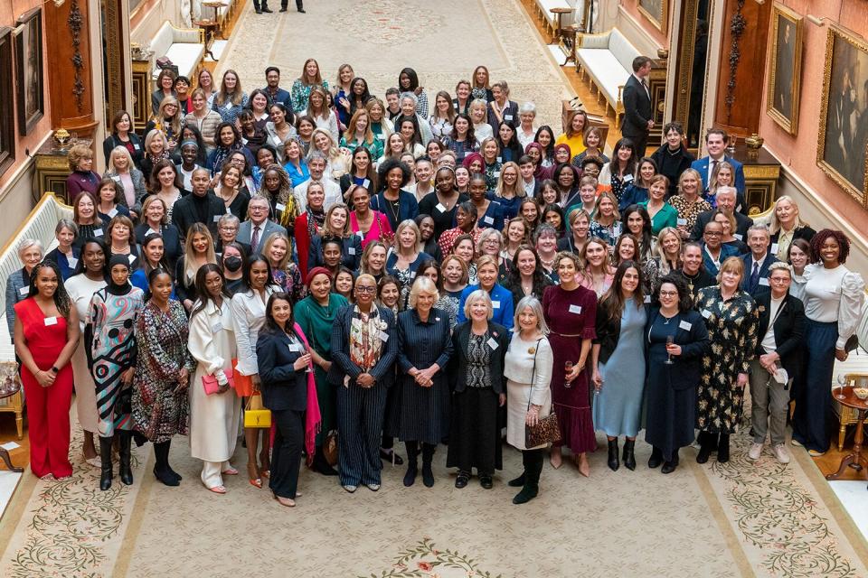 Camilla, the Queen Consort, in a group photo with guests during a reception at Buckingham Palace for International Women's Day, on March 8, 2023 in London, England.