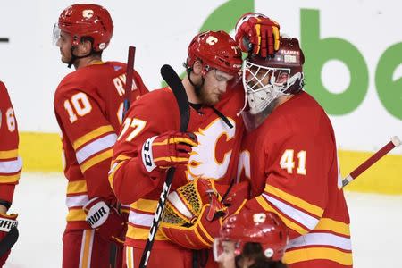 FILE PHOTO: Apr 19, 2019; Calgary, Alberta, CAN; Calgary Flames center Mark Jankowski (77) and goalie Mike Smith (41) react after their game against the Colorado Avalanche in game five of the first round of the 2019 Stanley Cup Playoffs at Scotiabank Saddledome. Avalanche won 5-1. Mandatory Credit: Candice Ward-USA TODAY Sports