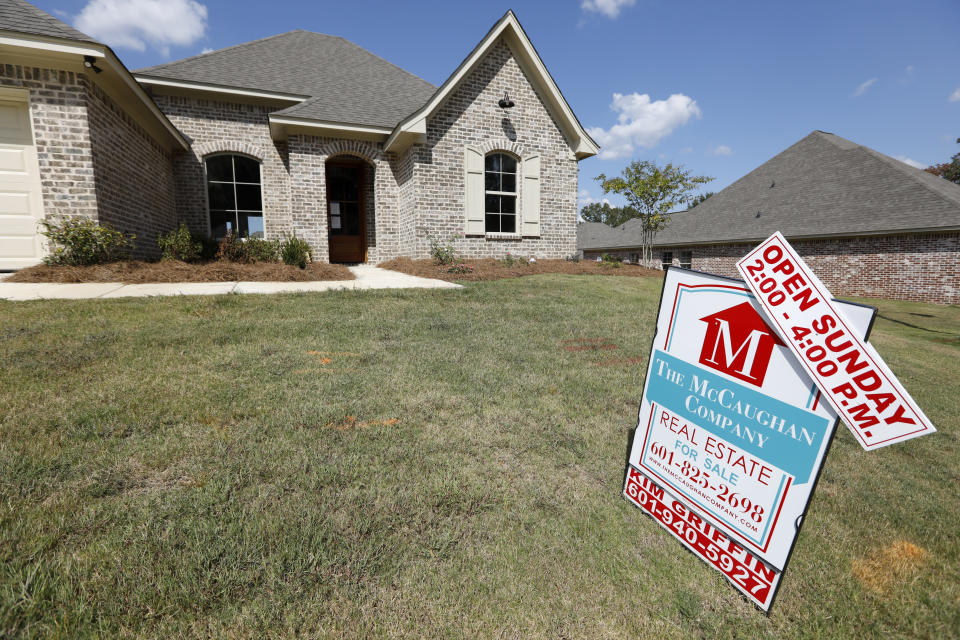 FILE - In this Sept. 25, 2019 file photo, a sign promoting an open house sits atop a realty company's lawn sign in Brandon Miss. On Thursday, May 28, 2020, Freddie Mac reports on this week’s average U.S. mortgage rates. (AP Photo/Rogelio V. Solis, File)