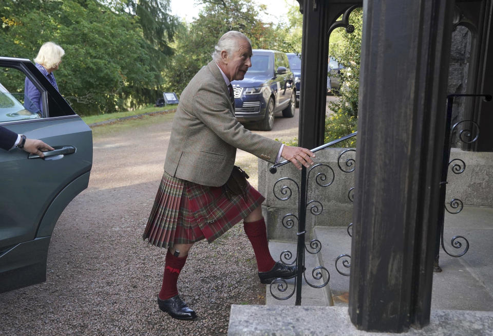 Britain's King Charles III, and Queen Camilla, background left, arrive at Crathie Parish Church for a church service to mark the first anniversary of the death of Queen Elizabeth II, near Balmoral, Scotland, Friday, Sept. 8, 2023. (Andrew Milligan/Pool Photo via AP)