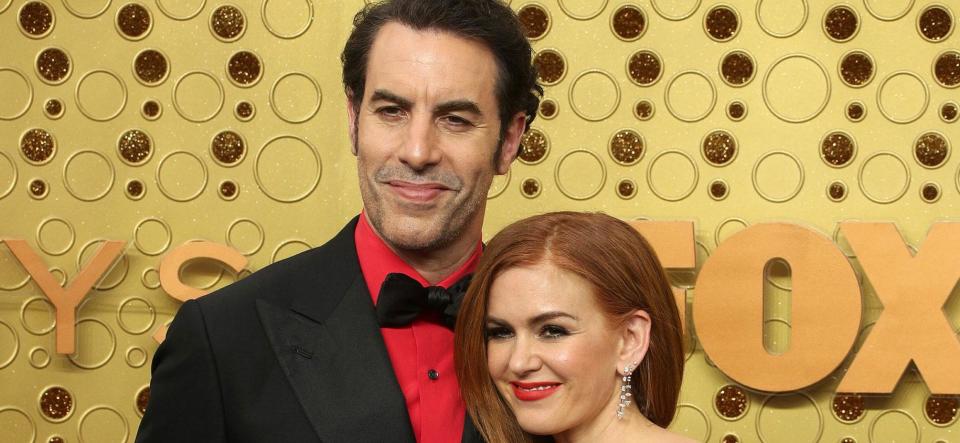 Sacha Baron Cohen and Isla Fisher smiling.