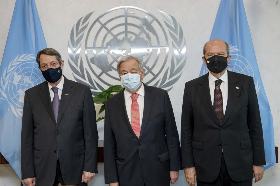 In this photo provided by the United Nations, Secretary General Antonio Guterres, center, meets Greek Cypriot Leader Nicos Anastasiades, left, and Turkish Cypriot Leader Ersin Tatar, at U.N. headquarters, Monday, Sept. 27, 2021. (Mark Garten/U.N. via AP)