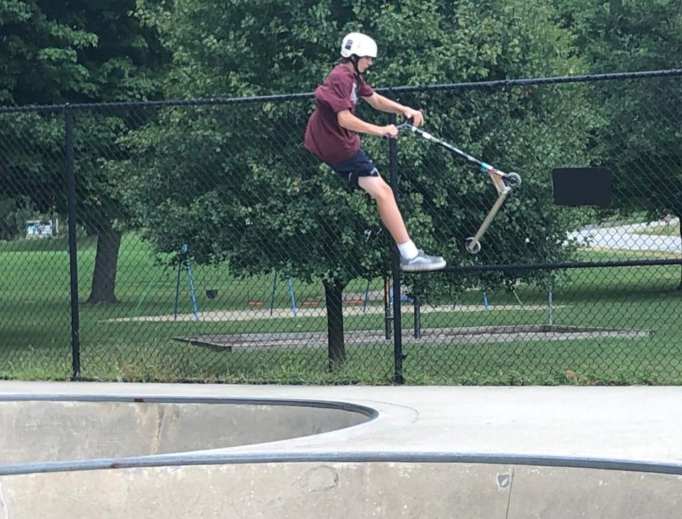 Sean Dauss, 14, catches air after riding along the bowls of the O'Brien Skate Park in South Bend on Sept. 8. 2023.