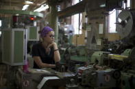 Sandra Cardenas, 20, works on her station at a factory of cigarette-maker Brascuba in Havana May 11, 2015. REUTERS/Alexandre Meneghini