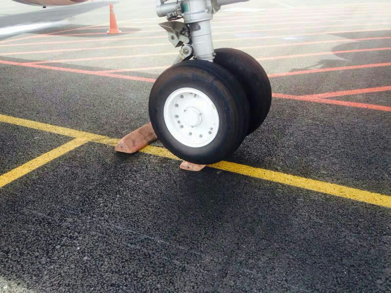 Plane tyre over the safety chock in klia2. – The Malaysian Insider pic, May 20, 2014.