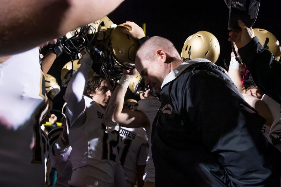 Delone Catholic head coach Corey Zortman leads the Squires in prayer following a 31-28 double-overtime win against York Catholic at York Catholic Stadium on Friday, September 30, 2022.