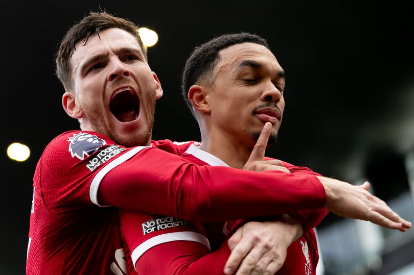 Trent Alexander-Arnold of Liverpool celebrates with Andy Robertson after scoring his side's first goal during the Premier League match against Fulham at Craven Cottage on April 21 2024