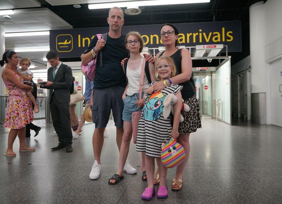 Matt and Christina Gillmore, with their children Ivy Rose (2nd left), aged 12, and Emily, aged 6, from Sidcup, Kent, arrive back on an easyJey flight from Rhodes in Greece into Gatwick Airport in Crawley, West Sussex. Up to 10,000 Britons are estimated to be on fire-ravaged Rhodes, with repatriation flights to rescue holidaymakers landing back in the UK. Picture date: Tuesday July 25, 2023.
