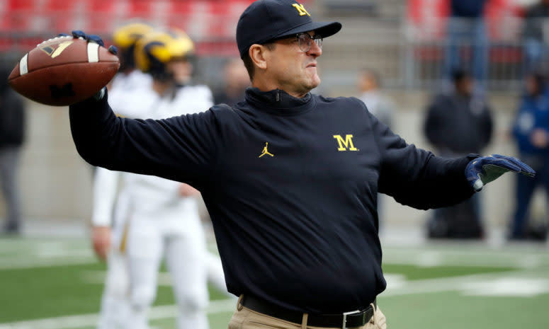 Jim Harbaugh throwing a pass during warmups.