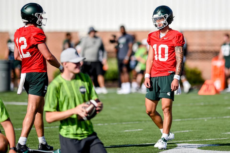 Michigan State quarterbacks Noah Kim, right, and Katin Houser talk during the opening day of MSU's football fall camp on Thursday, Aug. 3, 2023, in East Lansing.