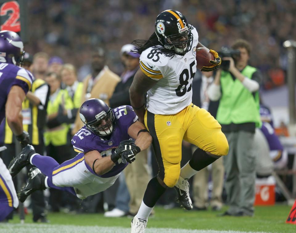 Pittsburgh Steelers tight end Johnson gets past Minnesota Vikings linebacker Greenway in the first quarter during their NFL football game at Wembley Stadium in London