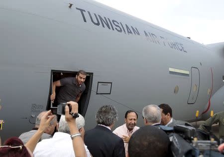 Tunisian diplomatic staff who were kidnapped in Libya a week ago, arrive at the airport in Tunis, Tunisia June 19, 2015. REUTERS/Zoubeir Souissi