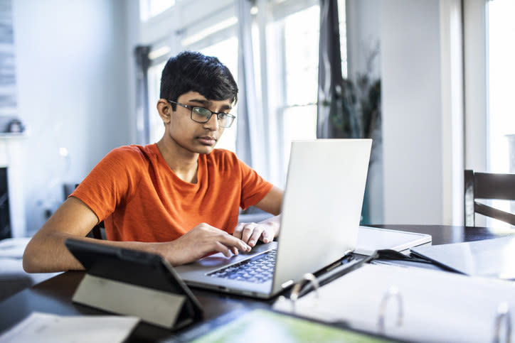 kid typing on computer