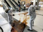 Protestors from climate change awareness collective Extinction Rebellion smear oil across the floor at the lobby of the Africa Oil Week conference in Cape Town