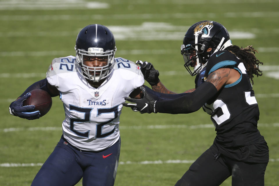 Tennessee Titans running back Derrick Henry (22) gains yardage as he tries to get around Jacksonville Jaguars cornerback Sidney Jones during the first half of an NFL football game, Sunday, Dec. 13, 2020, in Jacksonville, Fla. (AP Photo/Stephen B. Morton)
