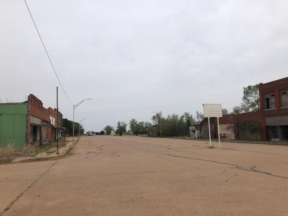 Buildings flank a wide and deserted thoroughfare